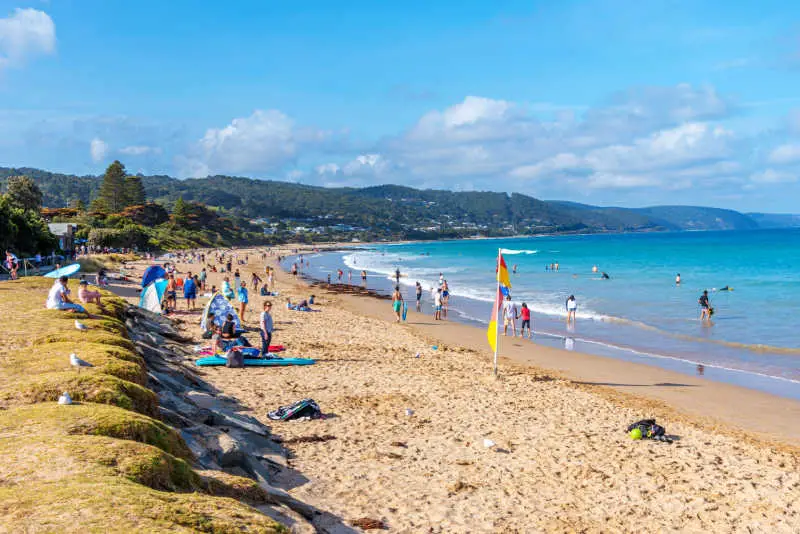 People enjoying a sunny day at Lorne Beach on the Great Ocean Road in Victoria Australia.