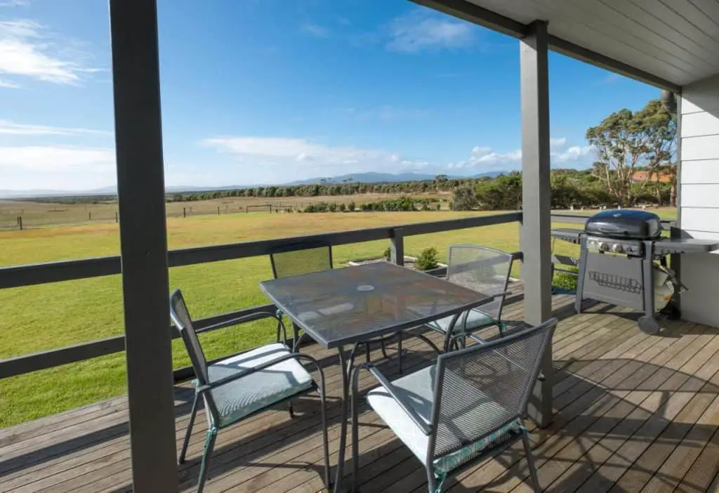 Outdoor deck with furniture and views over Corner Inlet at Wilsons Promontory.