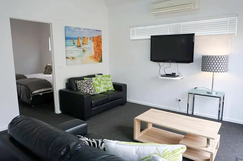 Guest room with TV, coffee table and lounge suite at Ashmont Motel and apartments Port Fairy accommodation.