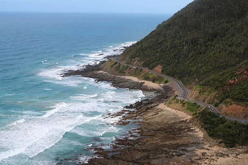 View of the Great Ocean Road in Victoria Australia with the ocean on one side and the Otways hinterland on the other.