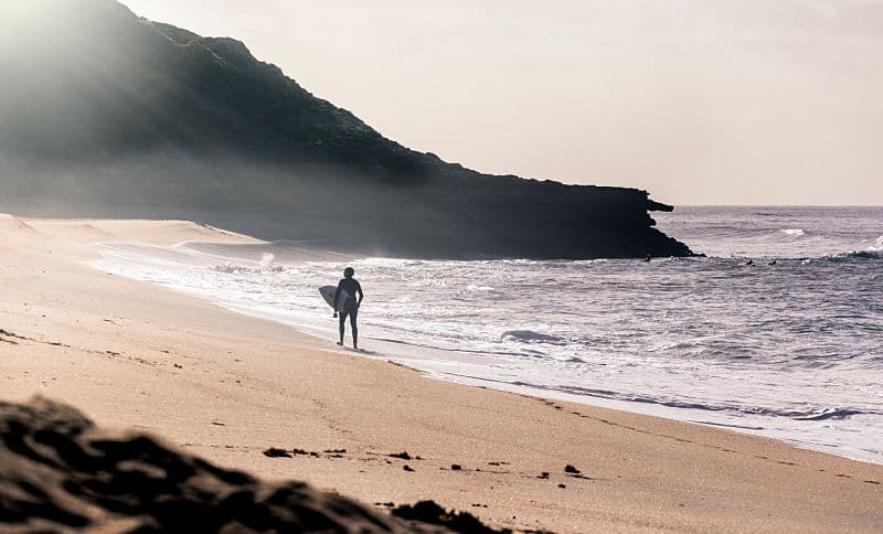 Surfer on the Torquay Victoria beach in the early morning mist.