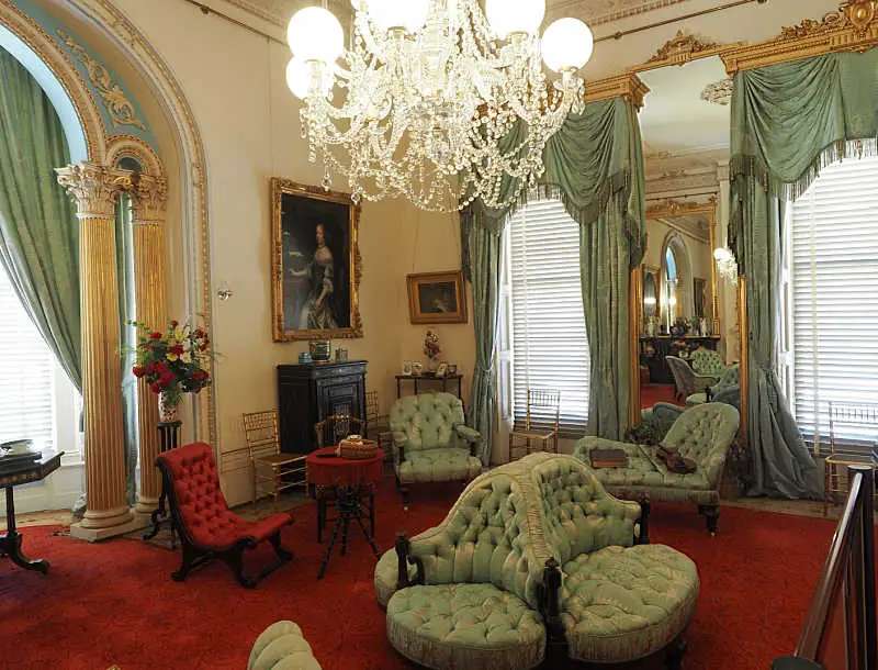 Beautiful drawing room at Werribee Park Mansion with chandeliers and occasional chairs.