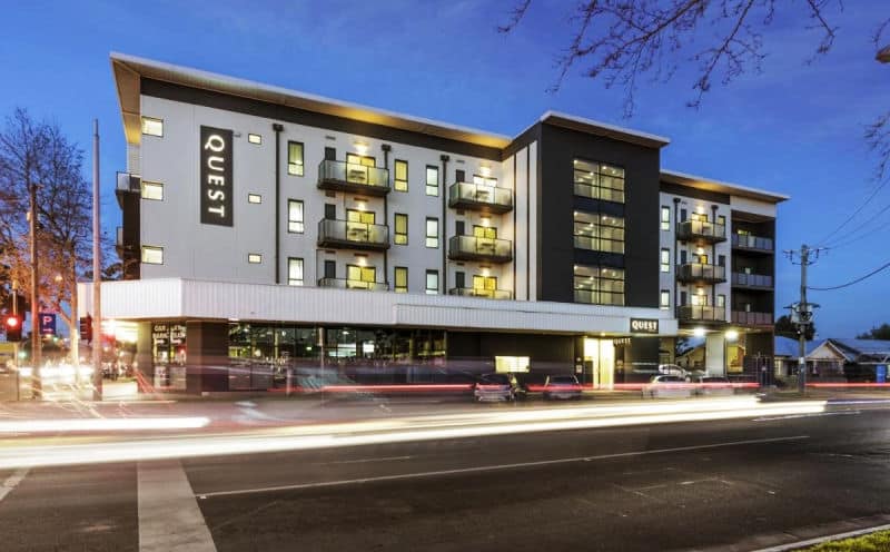 Image of the Quest Werribee Apartments at twilight with lights beaming through the windows.