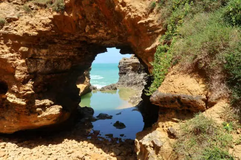 View of the ocean and horizon through The Grotto on the Great Ocean Road a must visit Port Campbell tourist attraction.