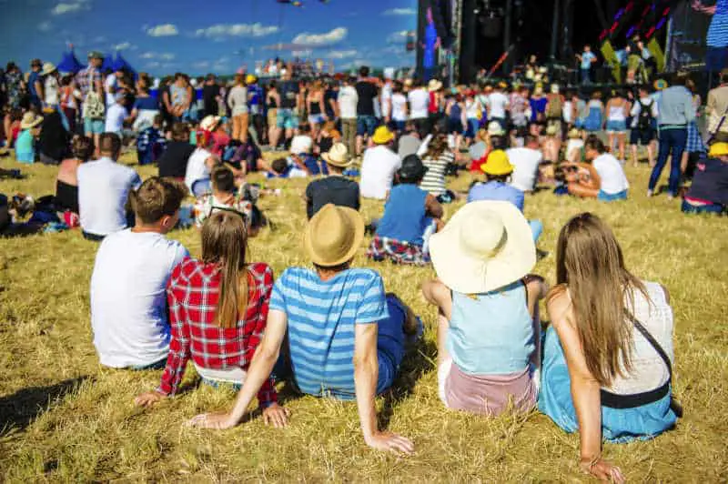 Festival goers sitting on the grass at Port Fairy Music Festival.