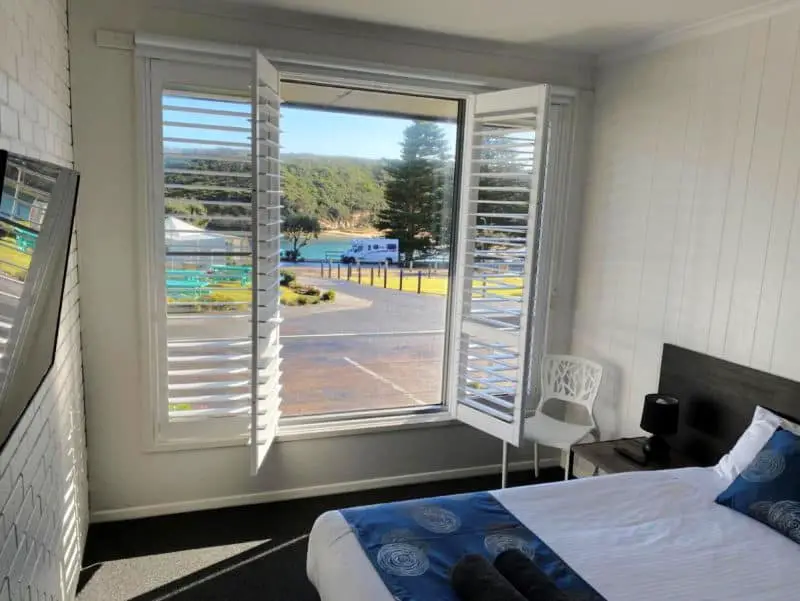 Guest room at Southern Ocean Motor Inn with open window overlooking the road and beach.