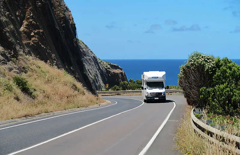 Campervan travelling along  the Great Ocean Road. Driving the Great Ocean Road is one of the top things to do in Anglesea Victoria.