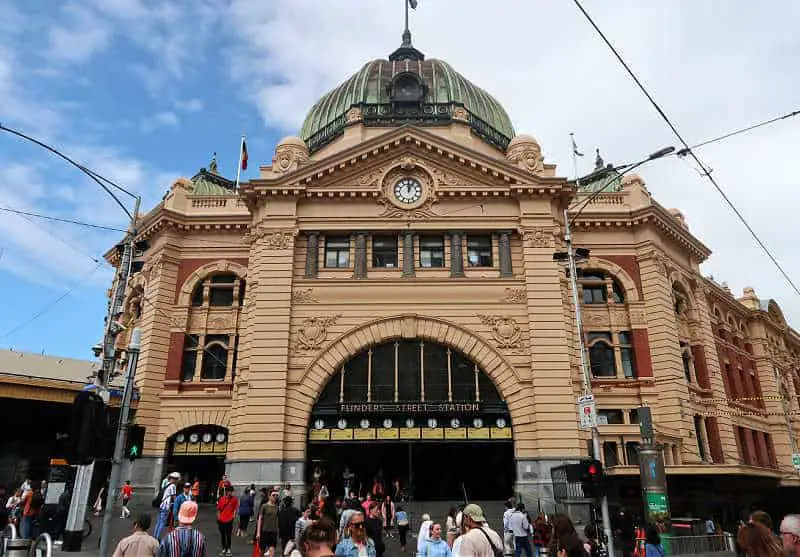 Commuters on the street and stairs at Flinders Street Station