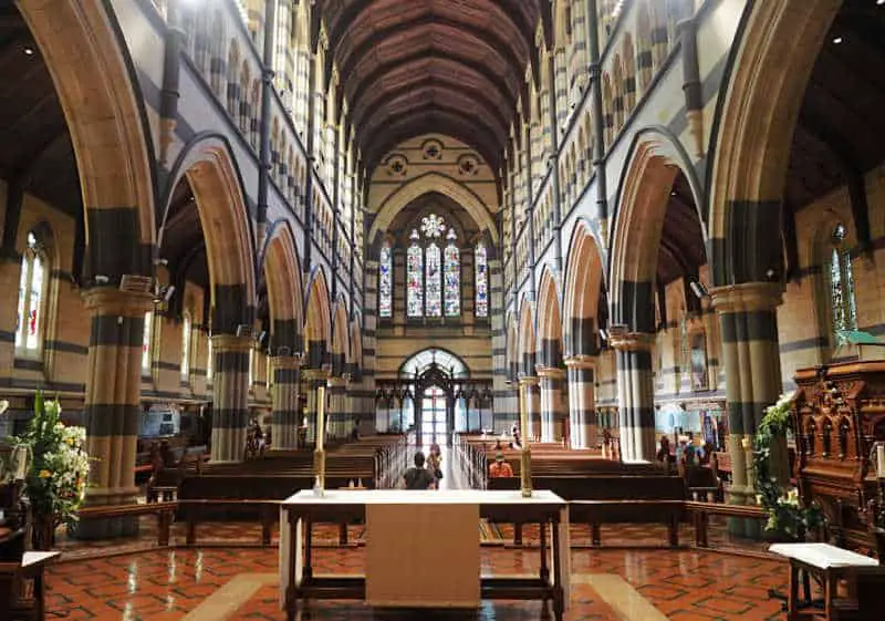 Pews and stained glass windows at St Paul's Cathedral one of the popular landmarks in Melbourne.