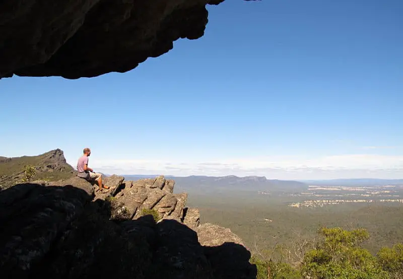 Man sitting admiring the view at The Balconies in the Grampians Victoria.