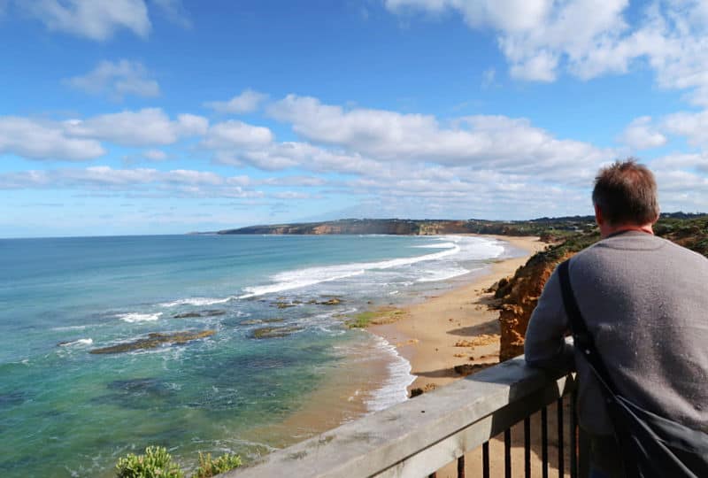 Tourist looking out over the ocean at Rocky Point Lookout on the Great Ocean Road. A stop here should be included in any Great Ocean Road 4 days trip.