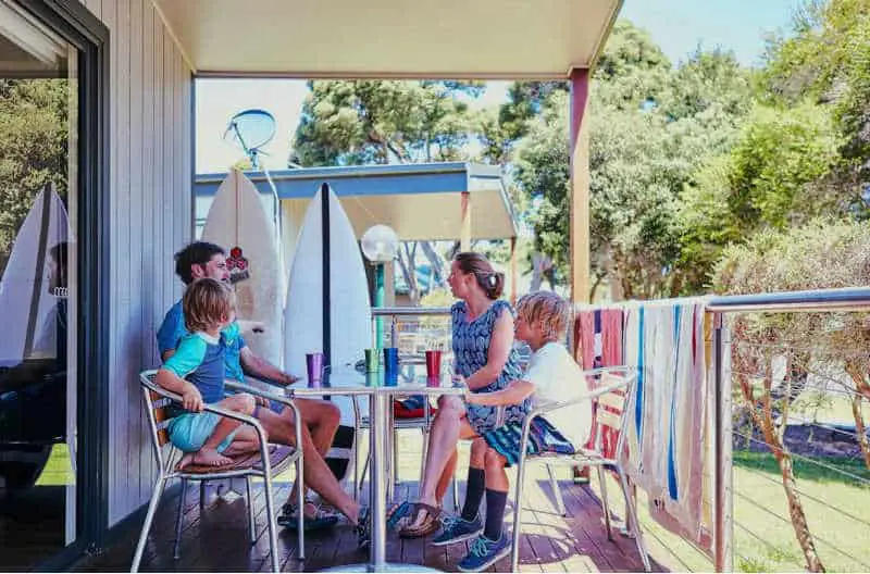 Family relaxing on their deck at Anglesea Family Caravan Park one of the top-rated Great Ocean Road Caravan Parks.