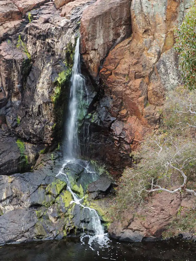 Nigretta Falls at a slow trickle tumbling over the cliff to the pool below in Southern Grampians Victoria.