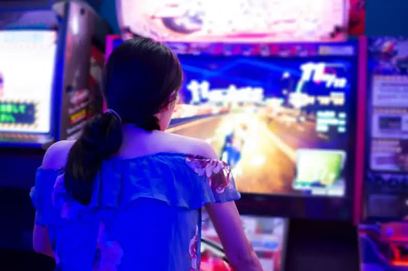 Person playing an arcade game.