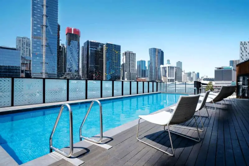 The pool area and city skyline at Peppers Docklands Melbourne.