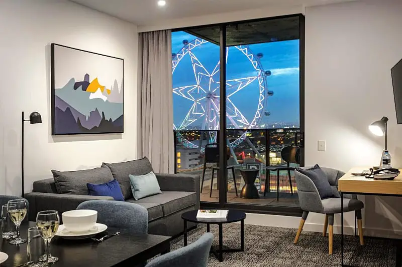 Guest room living area with view of the Melbourne Star Observation wheel.