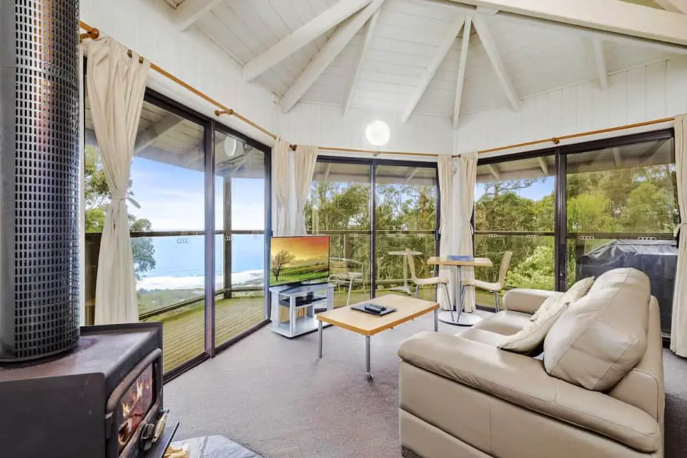 Living room at Beacon Point Ocean View Villas with floor to ceiling windows overlooking the ocean.