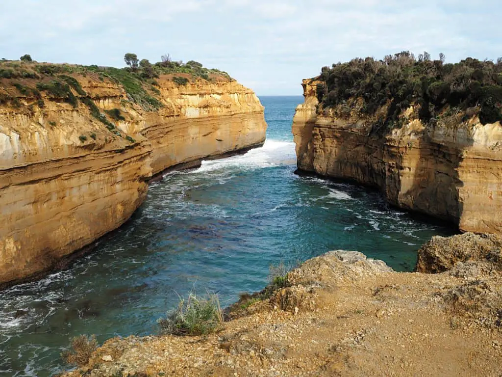 Loch Ard Gorge should be on everyone's Great Ocean Road 2 day itinerary. Soaring green covered cliffs jut out into the crashing waves of the Southern Ocean.