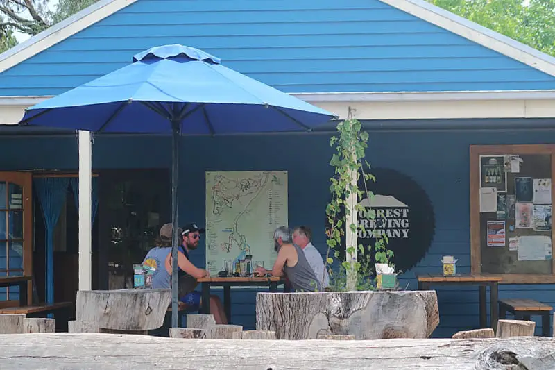 Group of people enjoying a drink on the verandah Forrest Brewery in the Otways in Victoria.