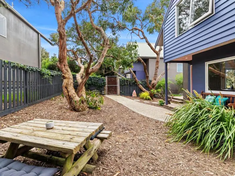 Garden with outdoor setting and trees at Point Roadknight Paradise Villa 6 in Anglesea Australia.