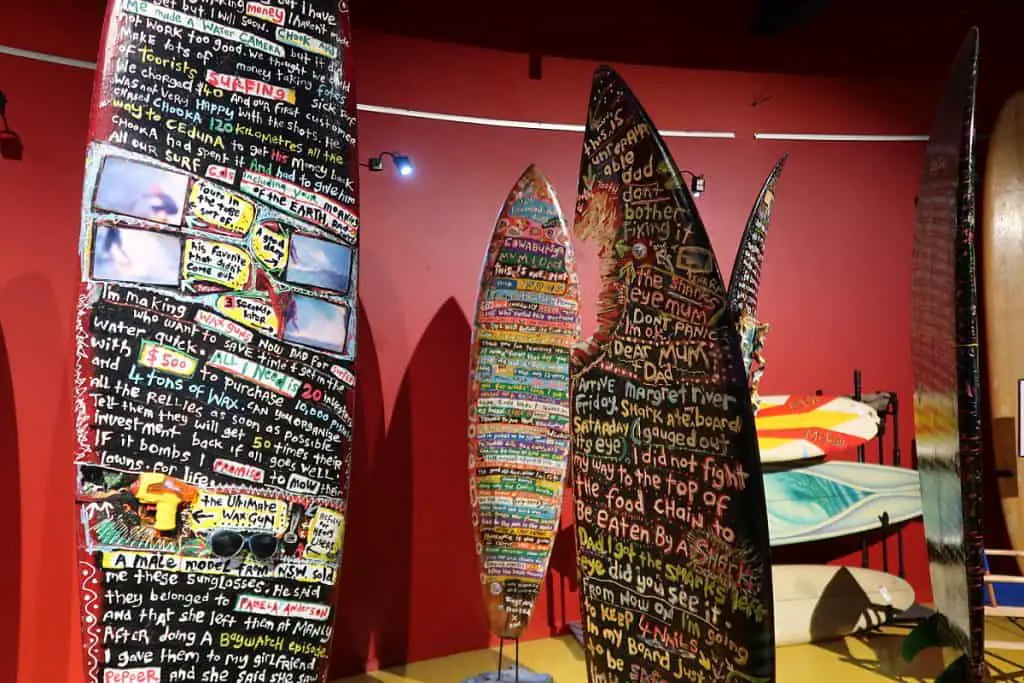 Surf boards with graffiti and shark bites taken out of them at the Torquay Museum.  