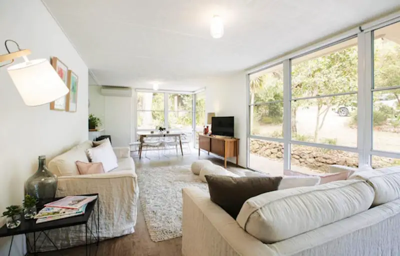 Living area with huge windows looking out to a garden at Twiggy@Anglesea a lovely holiday rental in Anglesea.