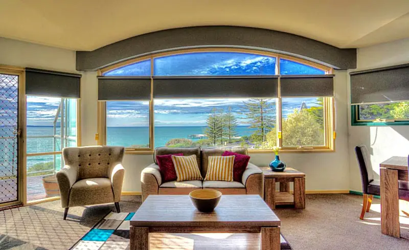 Guest room with large windows overlooking the ocean at Pierview Lorne holiday apartments.