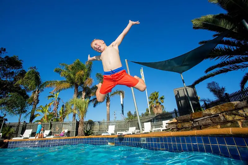 Child jumping into the pool at the Torquay Holiday Park.