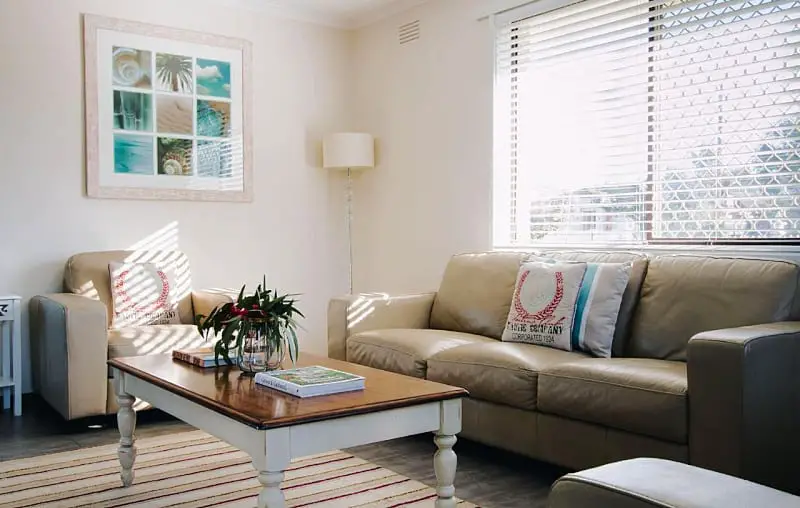 Living room at Torquay Retreats with coffee table, couch, and wall art.