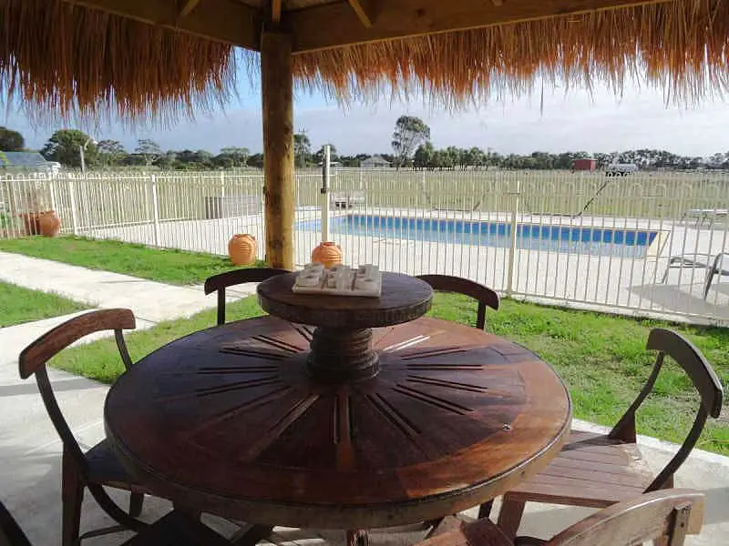Picnic table with umbrella and views of the pool at Oxley Estate Portarlington.