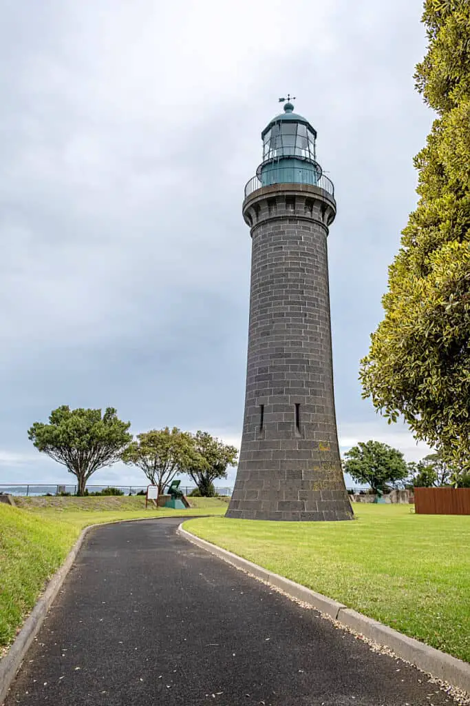 Path leading to the Queenscliff Black Lighthouse with green grass and trees. There are only 3 black lighthouses in the world and this is the only one in the Southern Hemisphere.