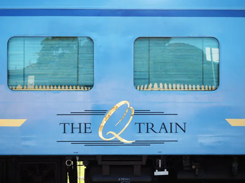 Blue carriage with gold Q logo on the Q Train in Queenscliff. A dine dining experience aboard a train.