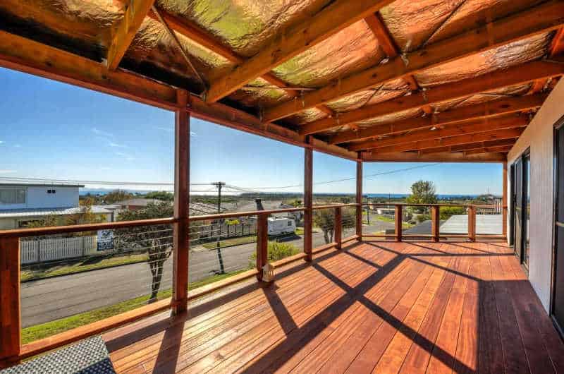 Large timber deck area on a clear blue day at Bayviews Portarlington holiday accommodation.