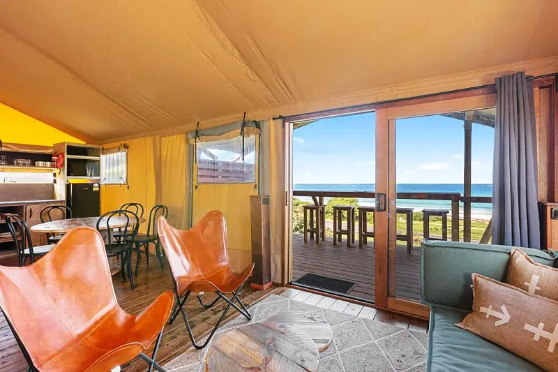 Living area with views out to a deck and the ocean at Big4 Pisces Holiday Park Apollo Bay accommodation.
