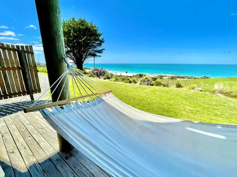 Deck with a hammock and beautiful blue ocean views at Castaways Apollo Bay accommodation.