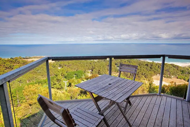 Balcony with outdoor setting and panoramic ocean views at Chris's Beacon Point Restaurant and Villas in Apollo Bay on the Great Ocean Road in Victoria.