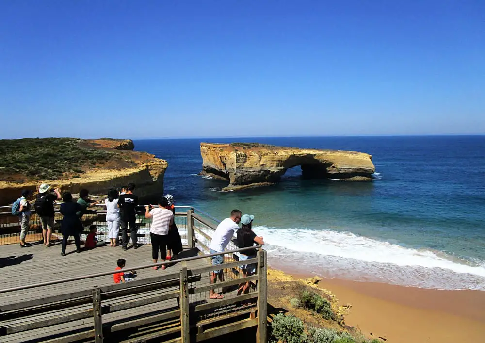 People viewing London Bridge on the Great Ocean Road from a lookout platform.