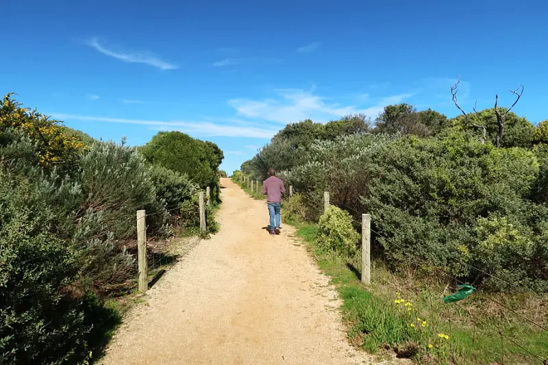 Andrew walking along a cliff top path at Aireys Inlet in Victoria Australia.