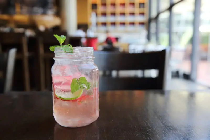 Pink gin cocktail in a glass jar with sprigs of mint at Great Ocean Road Gin Kitchen in Aireys Inlet.