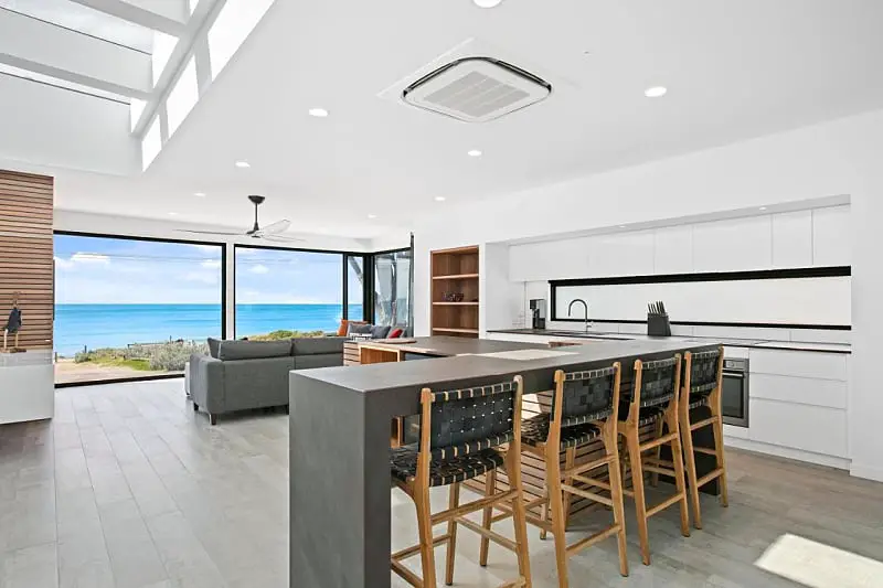 Open plan kitchen, living, and dinging area with ocean views at Apollo Bay Beach House on the Great Ocean Road in Victoria.