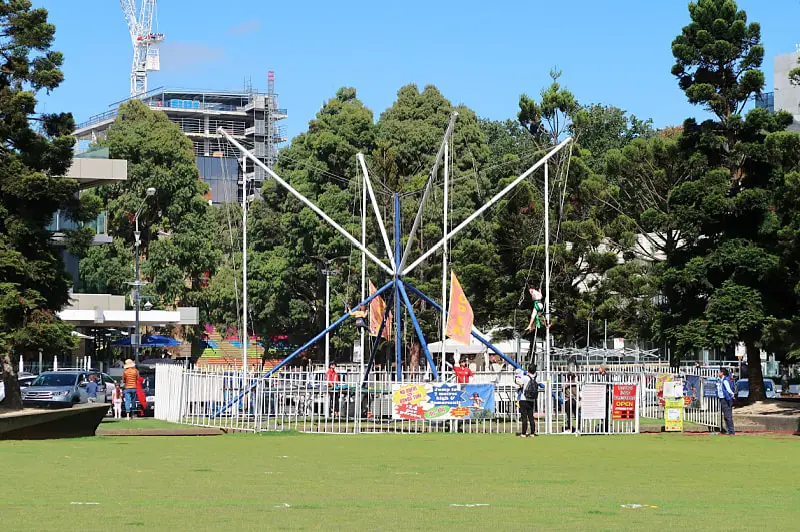 View of the Bungy Trampolines at Geelong Waterfront surrounded by a large expanse of grass and trees.