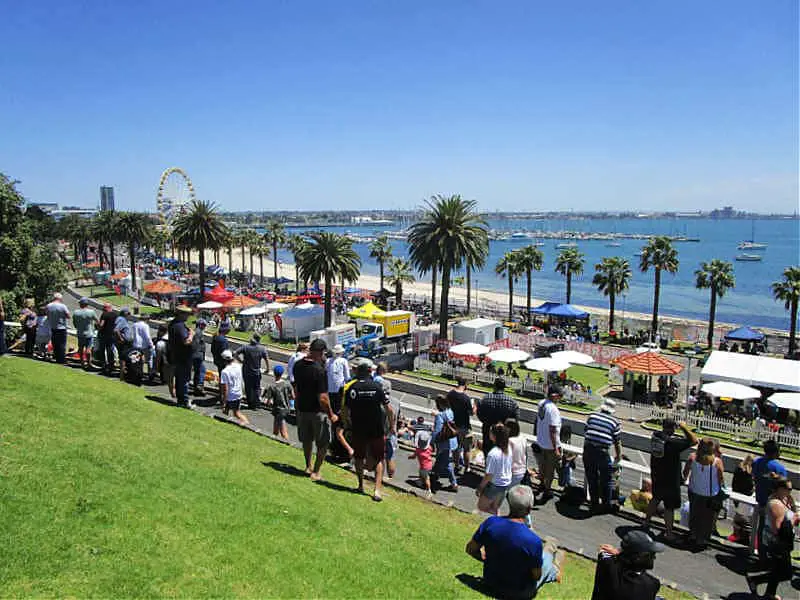 People gathered on the grass slopes of the Geelong Waterfront at the Geelong Revival motor car event.