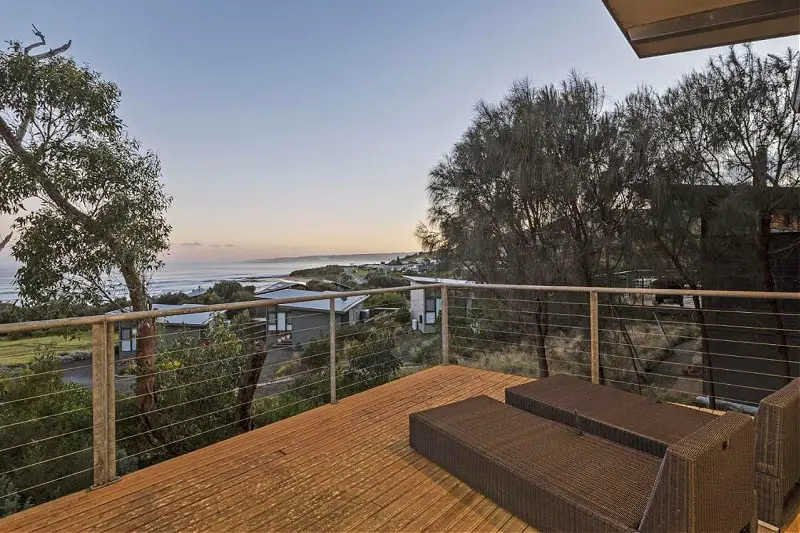 Outdoor decked area and lounge chairs with sunset views at Skenes Beach House Apollo Bay. 